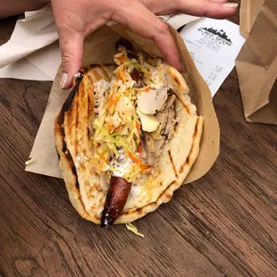 Ronto Wrap (Roasted Pork, Grilled Pork Sausage, Peppercorn Sauce, Tangy Slaw Wrapped In A Pita)!