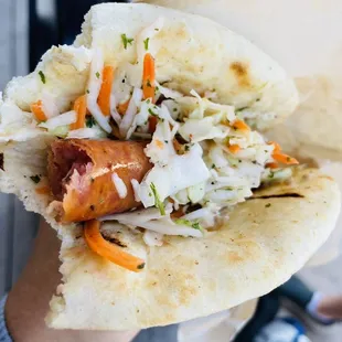 a person holding a hot dog