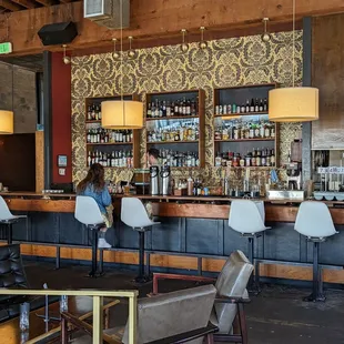 a bar with people sitting at the bar