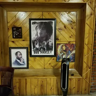 a wood paneled wall with pictures and a fan