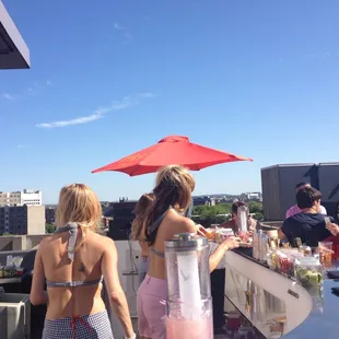 a group of people standing at a bar