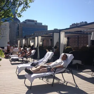 people lounging on lounge chairs