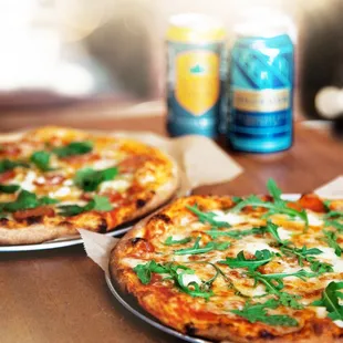 two pizzas and a can of beer