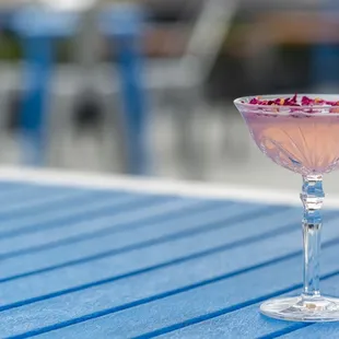 a pink cocktail in a coupe glass