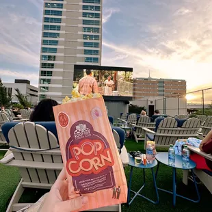 a person holding a bag of popcorn