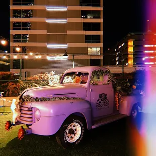 an old truck decorated with flowers
