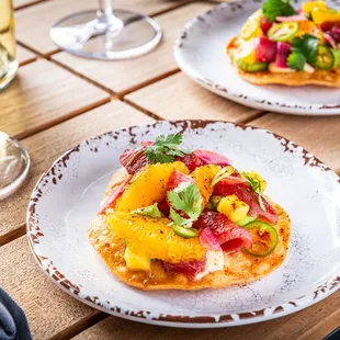 Savor the splash of the ocean and zest of the garden with our AHI TUNA TOSTADA .