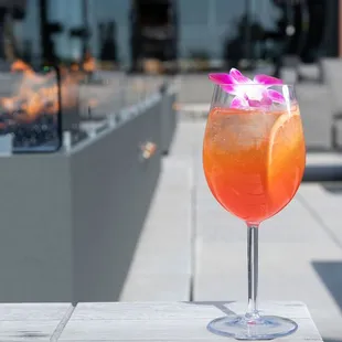 Discover a sip of Grecian sunset with our Santorini Spritz. Aperol infused with blood orange, passion fruit, elderflower, Prosecco &amp;  soda.