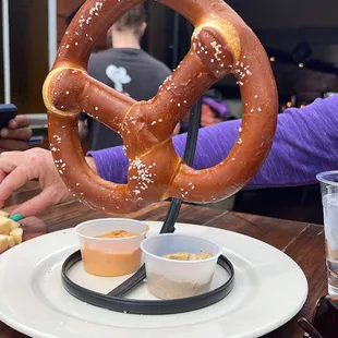 Pretzel with cheese and mustard dipping sauces