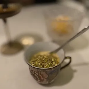 a cup of tea and a spoon on a table