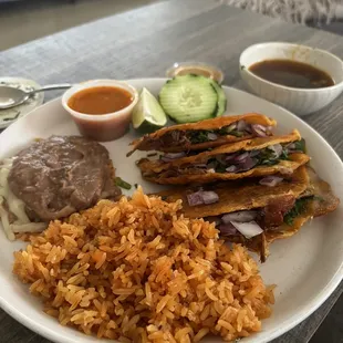 a plate of mexican food with rice and beans