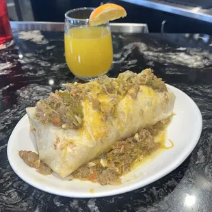 Bacon breakfast burrito smothered W hatch green chili.