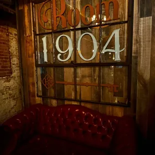a red leather couch in front of a window