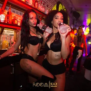 two women in bikinis at a bar