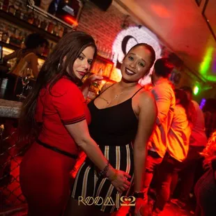 two women in red dresses posing for the camera