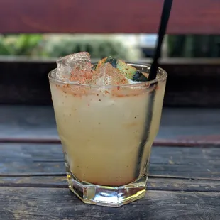 a glass with a drink on a wooden table