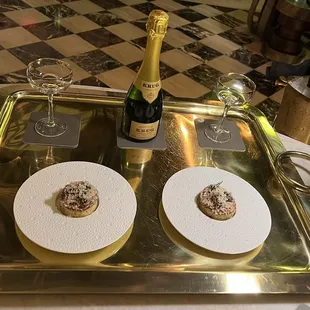 A glass of Krug with small plate pairing