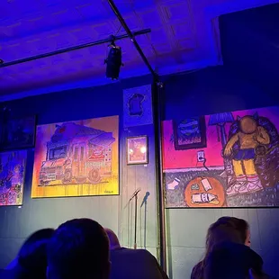 people sitting in front of a painting