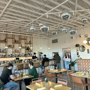 people sitting at tables in a restaurant