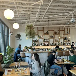 people sitting at tables in a restaurant