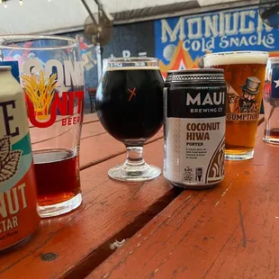 beer glasses and cans on a picnic table