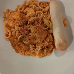 Seafood and pasta with a cheese stuffed bread.