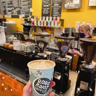 a person holding a cup of coffee
