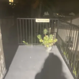 the shadow of a person on a balcony