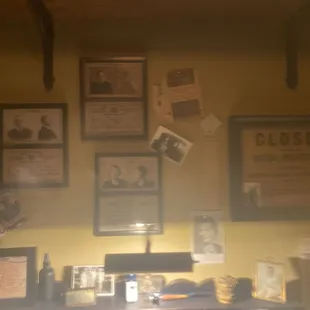 a desk with a lot of pictures on the wall