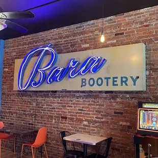 a brick wall with a neon sign