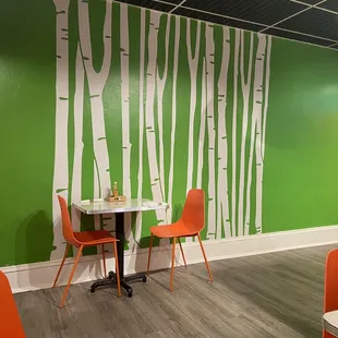 a green wall with white trees