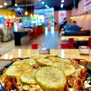 KALE-N-ROOZ 2 crispy chicken tenders chopped over kale Slaw topped with pickles and starz sauce.