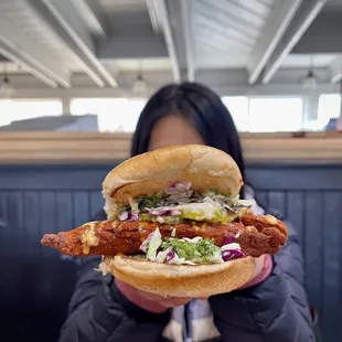 a woman holding a sandwich
