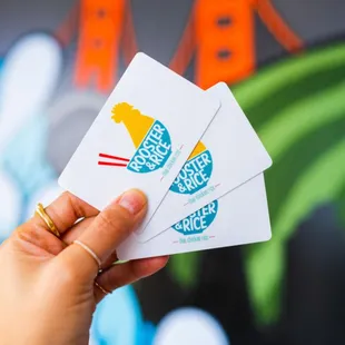 a hand holding four cards