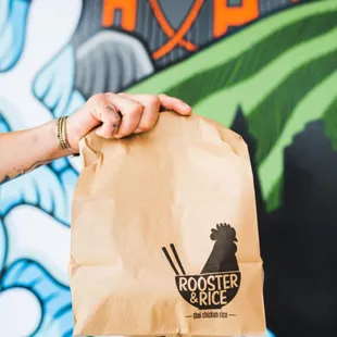 a person holding a paper bag