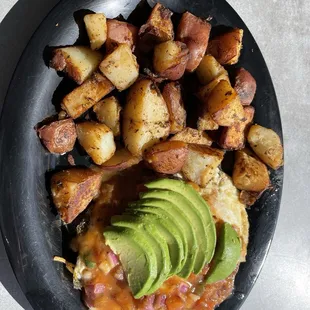 a plate of food with potatoes and avocado