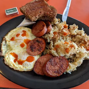 Two egg (over-easy) breakfast with sausage and hash browns