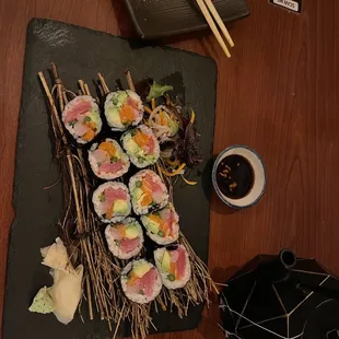 a plate of sushi and chopsticks