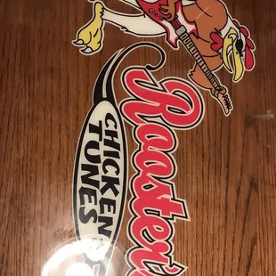 a close up of the logo on a wooden table