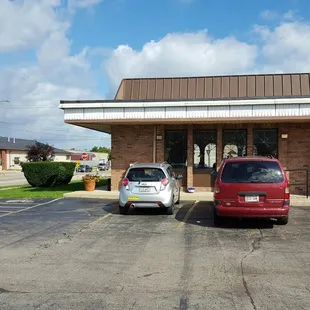 two cars parked in front of the restaurant