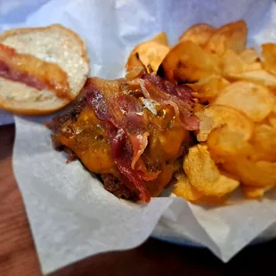 Garlic jalapeño bacon burger with chips for a side.