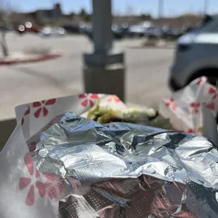 a sandwich wrapped in aluminum foil