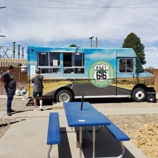 two people standing in front of the truck