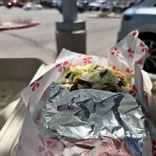 a sandwich wrapped in aluminum foil