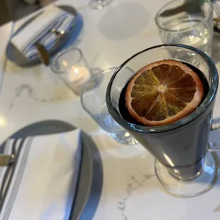an orange slice in a glass of water