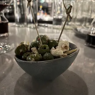 olives in a bowl with toothpicks