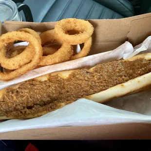 Footlong (homemade) chili-cheese dog and onion rings.