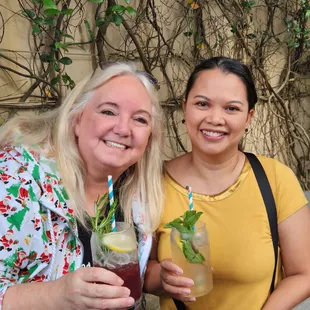 two women holding drinks