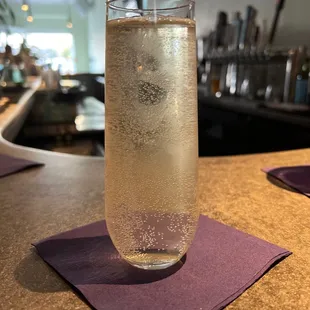 a glass of water on a purple napkin