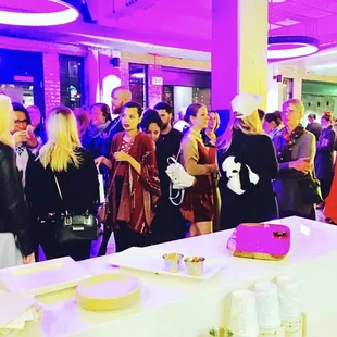 a group of people standing around a table